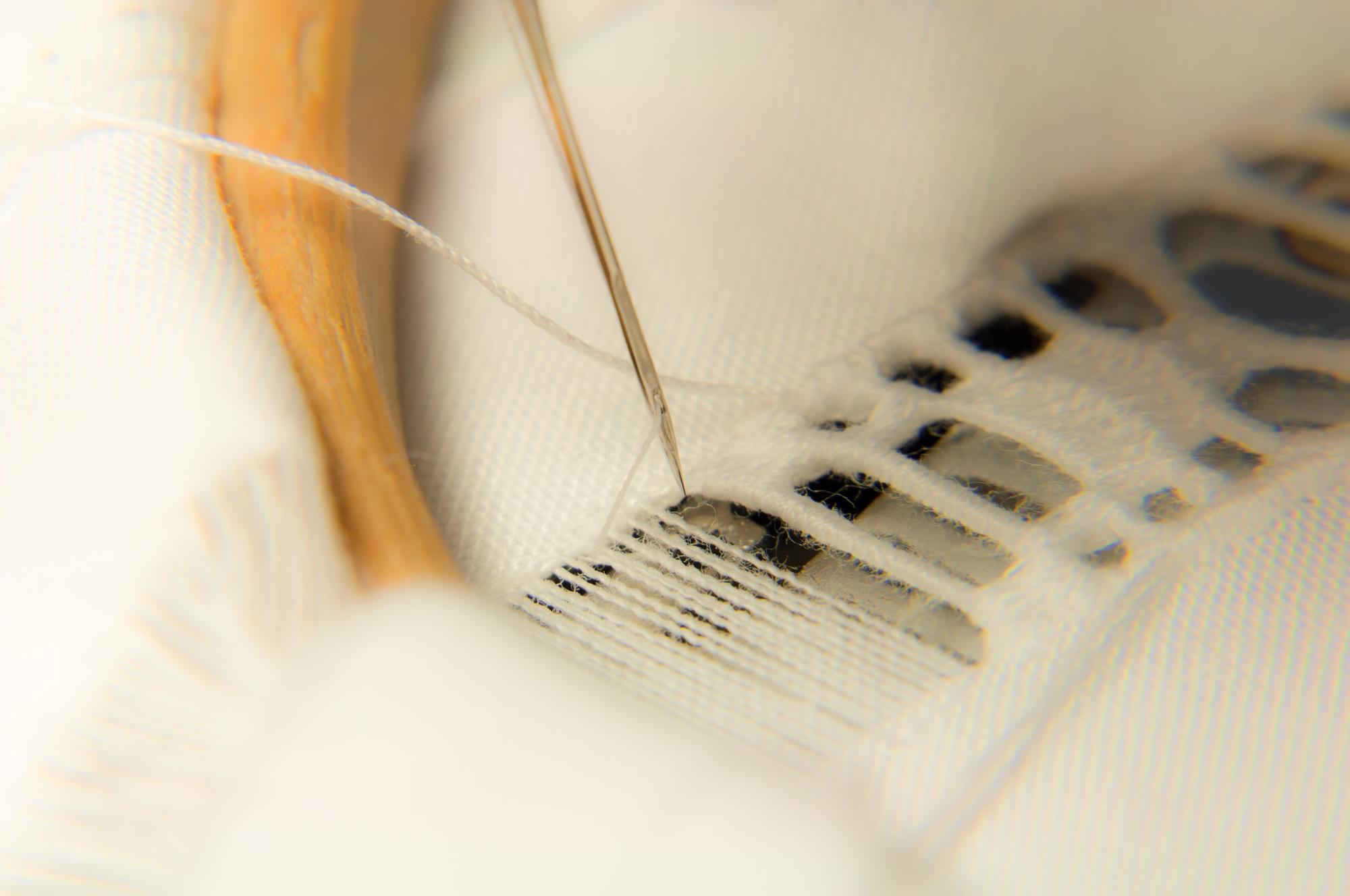 detailed embroidery on linen with threads and needles